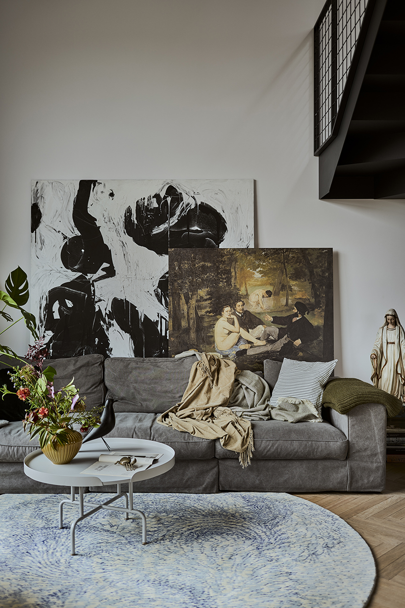 a steel staircase doubles as storage in this poznan apartment, designed by UGO designboom