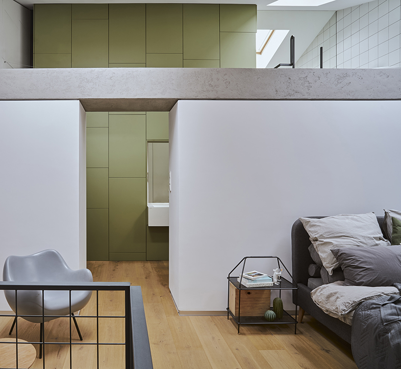 a steel staircase doubles as storage in this poznan apartment, designed by UGO designboom