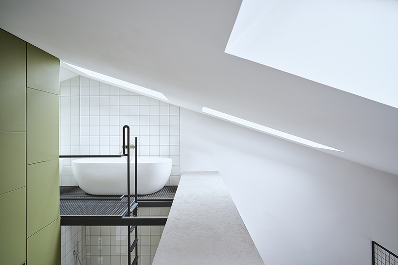 a steel staircase doubles as storage in this poznan apartment, designed by UGO designboom