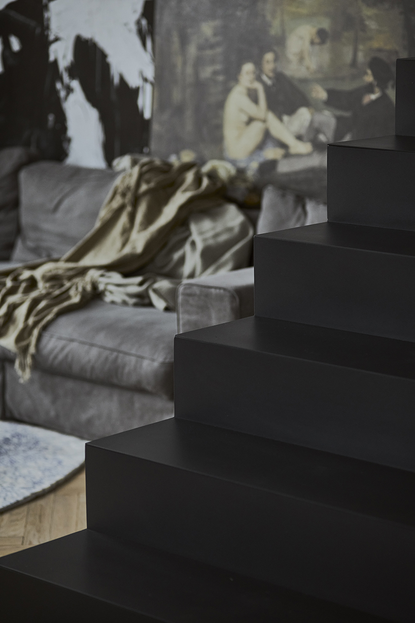 a steel staircase doubles as storage in this poznan apartment, designed by UGO designboom