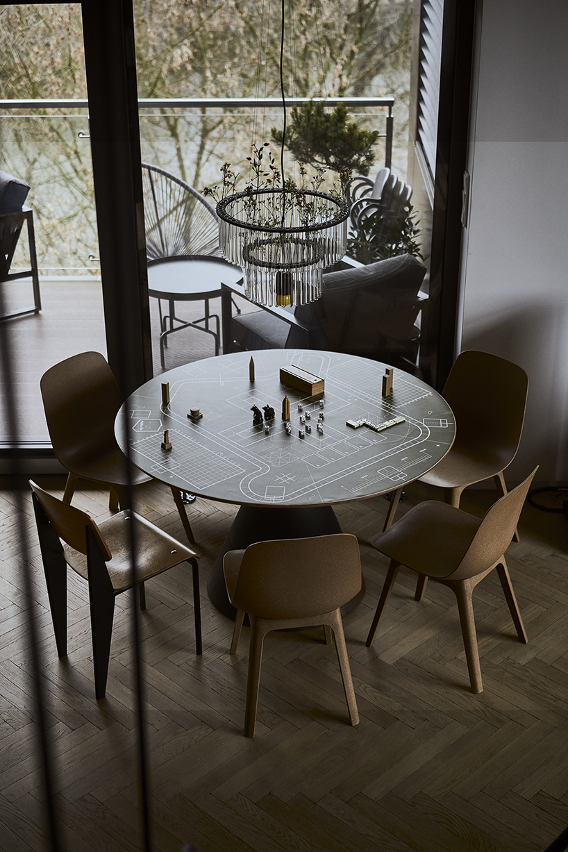 a steel staircase doubles as storage in this poznan apartment, designed by UGO designboom