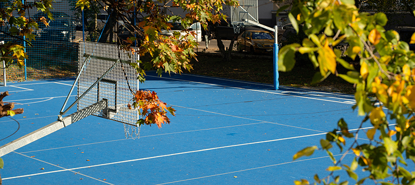 UGO completes a bright blue sports field in poznan, poland designboom