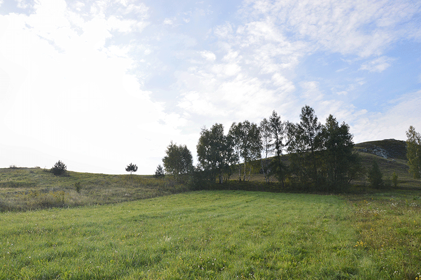 adrian kasperski weaves house into the hills of polish landscape - 4