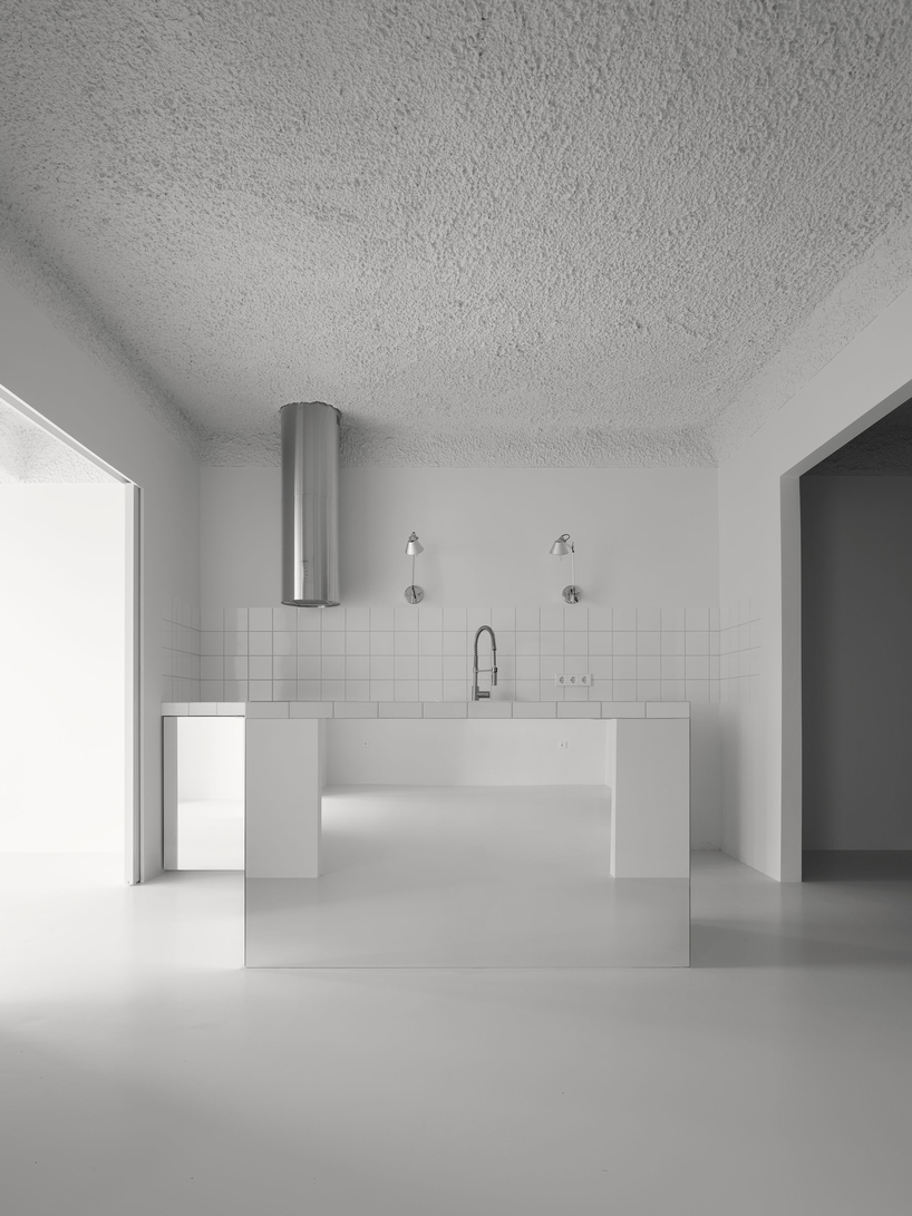 hanghar negates architecture in bare, abstract house responding to social standards