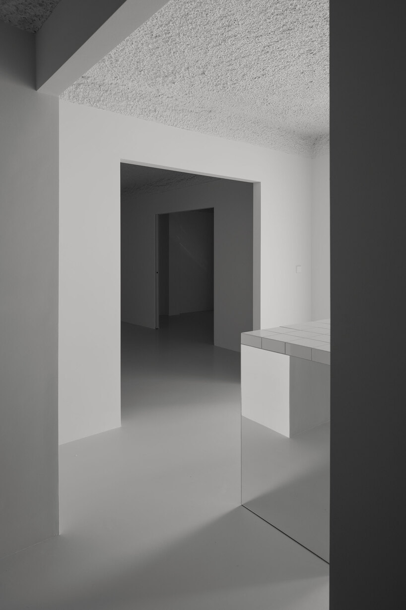 hanghar negates architecture in bare, abstract house responding to social standards