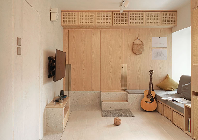 absence from island completes apartment interior in hong kong with rattan, wood + terrazzo