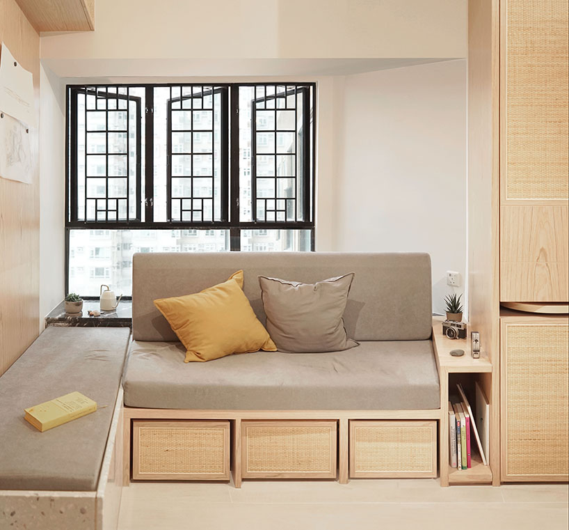 absence from island completes apartment interior in hong kong with rattan, wood + terrazzo