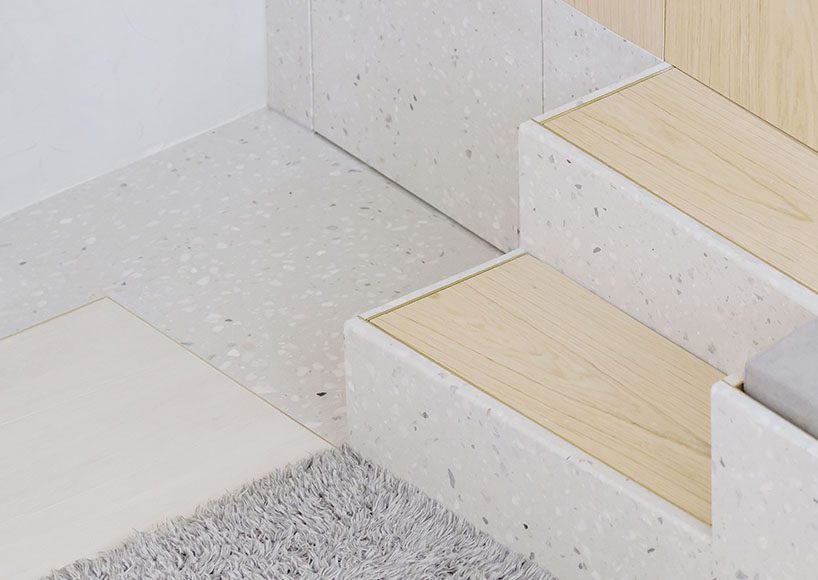 absence from island completes apartment interior in hong kong with rattan, wood + terrazzo