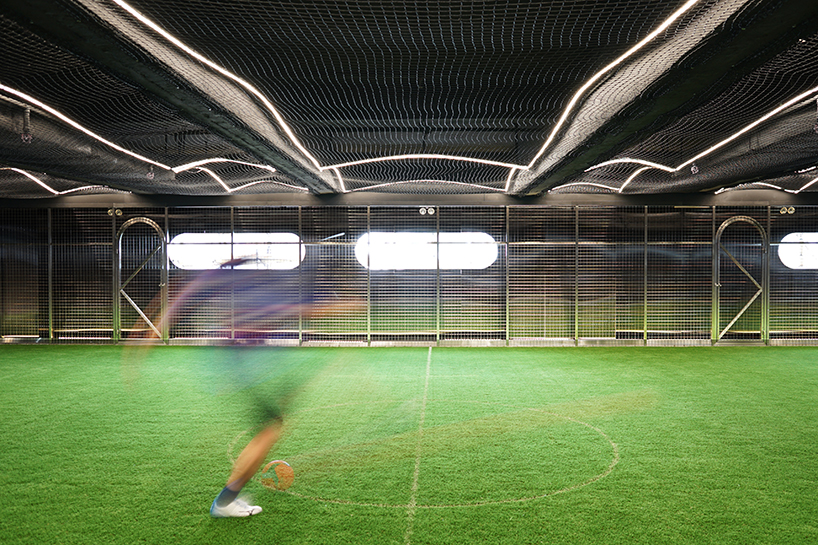 absence from island + studio etain ho turn a factory unit into a soccer pitch designboom
