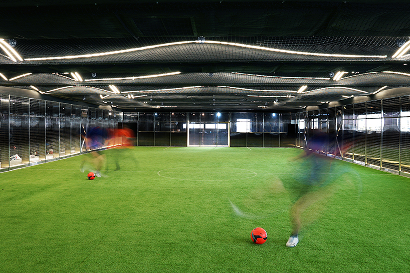 absence from island + studio etain ho turn a factory unit into a soccer pitch designboom