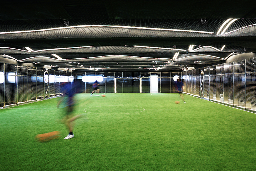 absence from island + studio etain ho turn a factory unit into a soccer pitch designboom