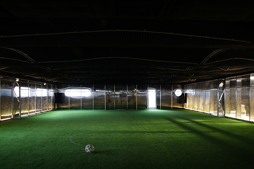 absence from island + studio etain ho turn a factory unit into a soccer pitch designboom