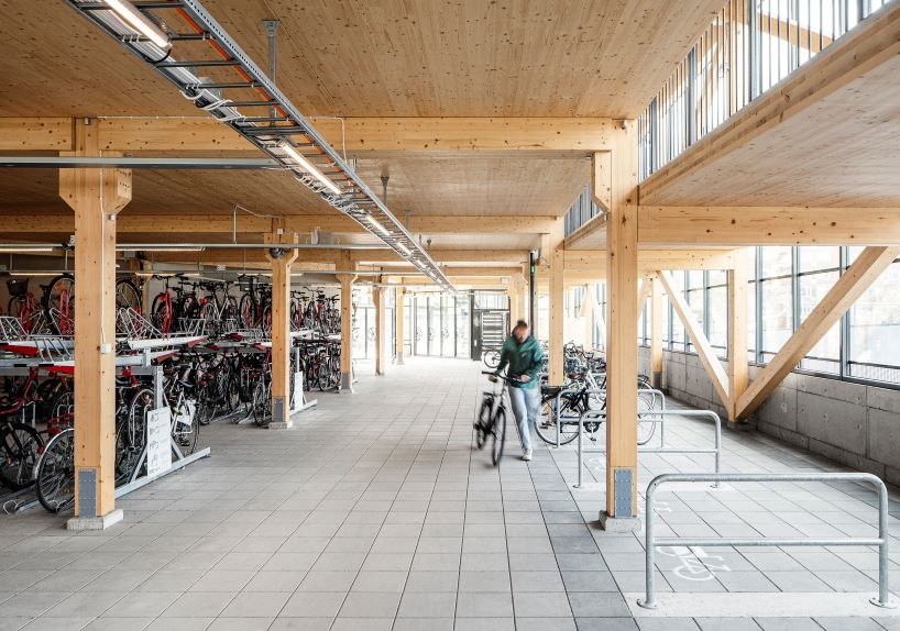 tengbom architects design sustainable triangular-shaped bicycle garage in sweden 