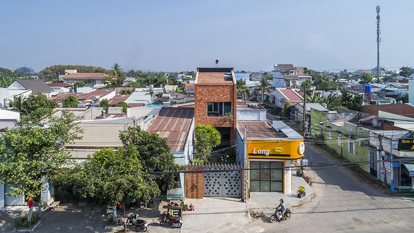 red brick and fish-scale tiles clad this family house by CTA in vietnam designboom