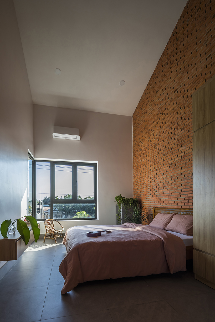 red brick and fish-scale tiles clad this family house by CTA in vietnam designboom