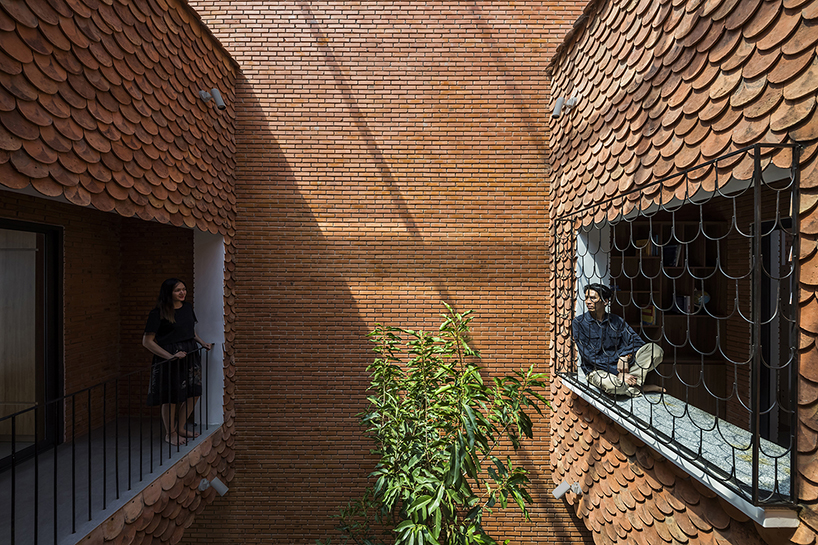 red brick and fish-scale tiles clad this family house by CTA in vietnam designboom