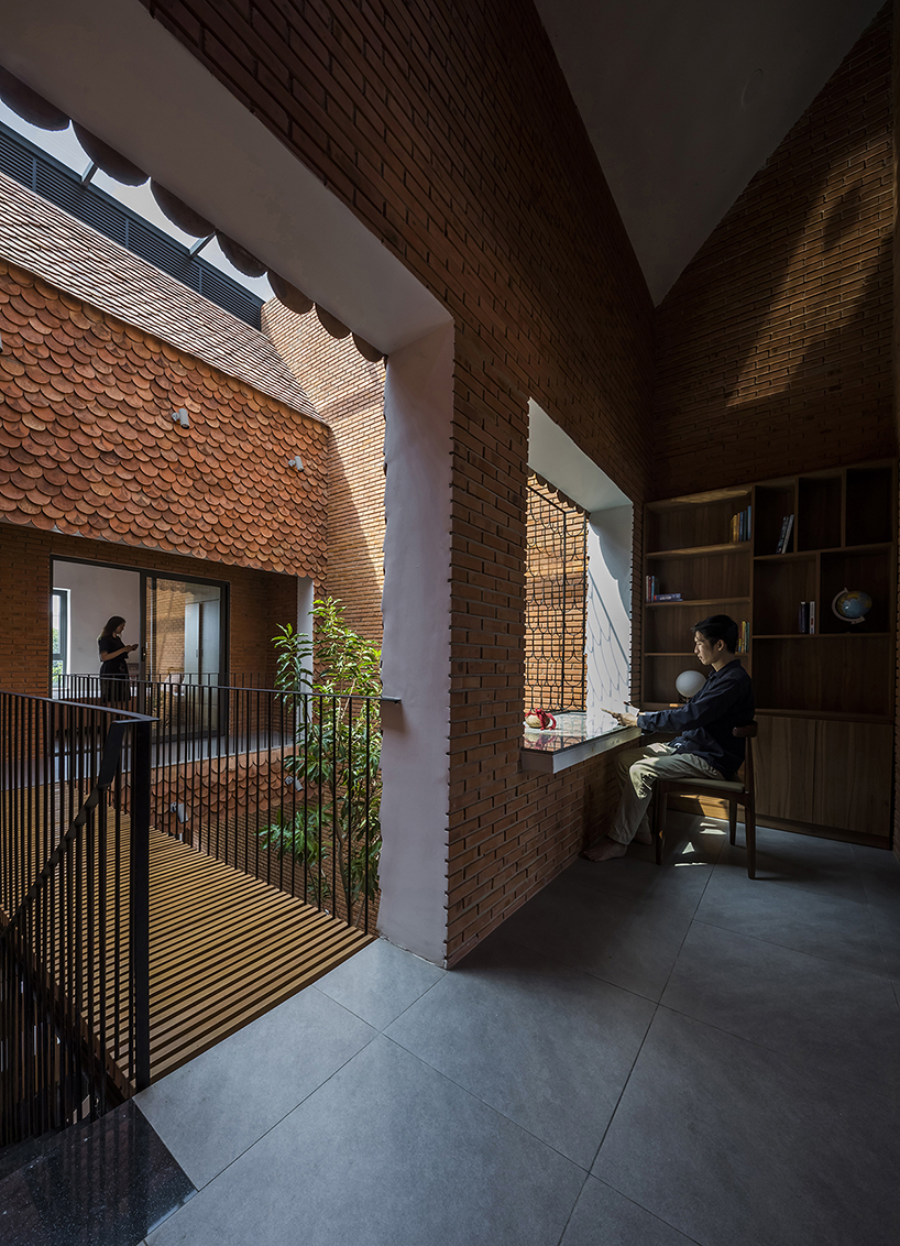 red brick and fish-scale tiles clad this family house by CTA in vietnam designboom