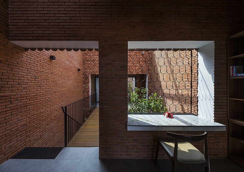 red brick and fish-scale tiles clad this family house by CTA in vietnam designboom