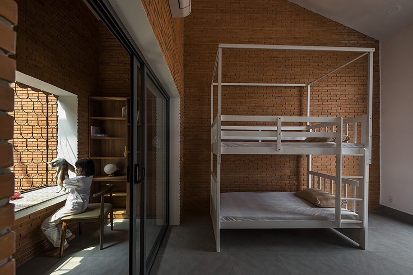 red brick and fish-scale tiles clad this family house by CTA in vietnam designboom