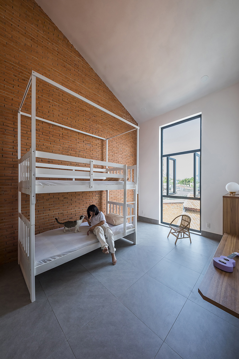 red brick and fish-scale tiles clad this family house by CTA in vietnam designboom