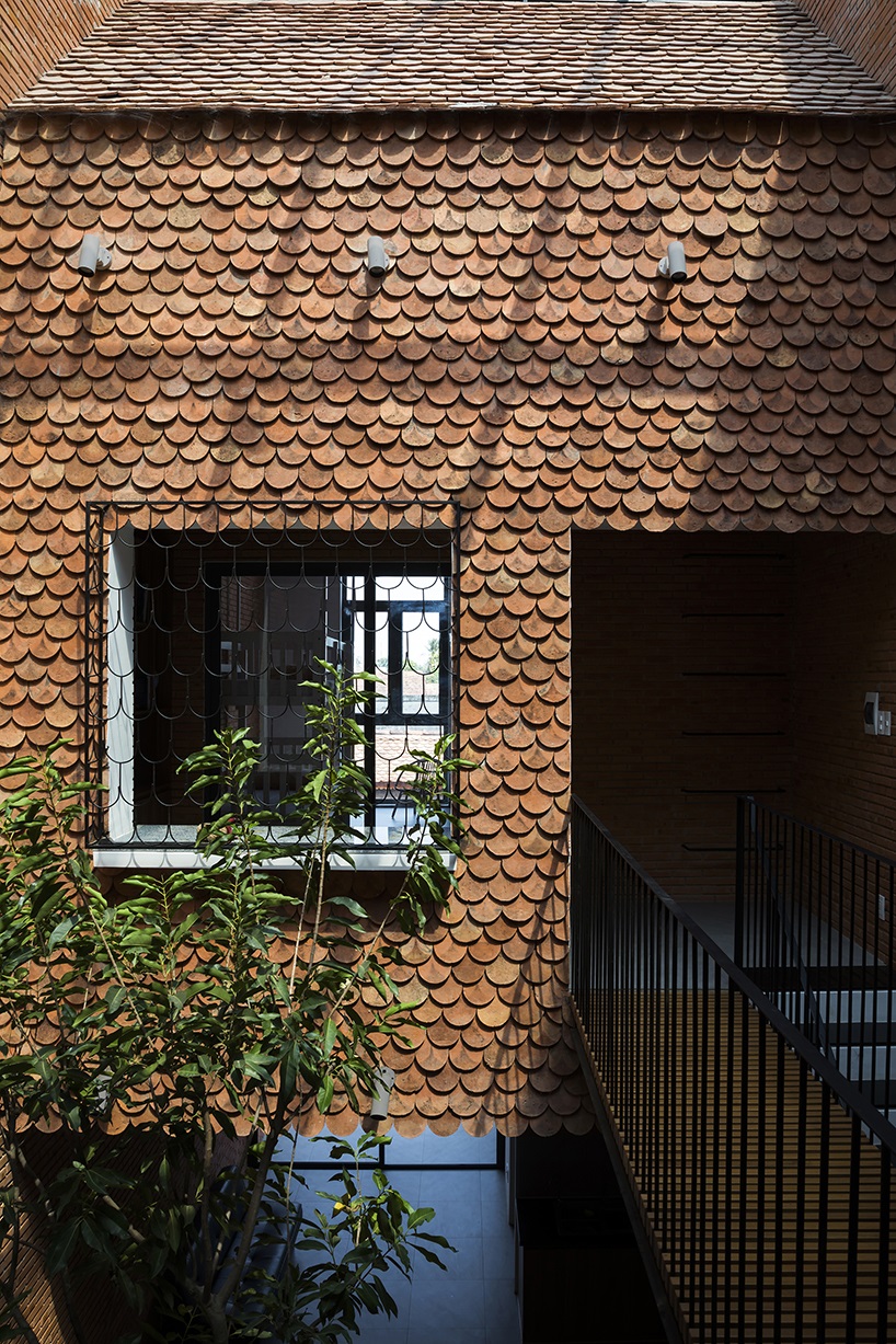 red brick and fish-scale tiles clad this family house by CTA in vietnam designboom