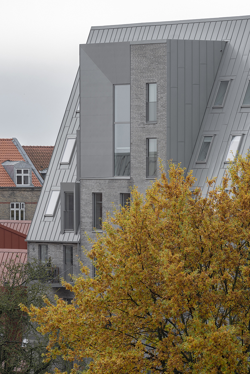 CEBRA designs a 'cozy cobbled streetscape' for aarhus apartments designboom