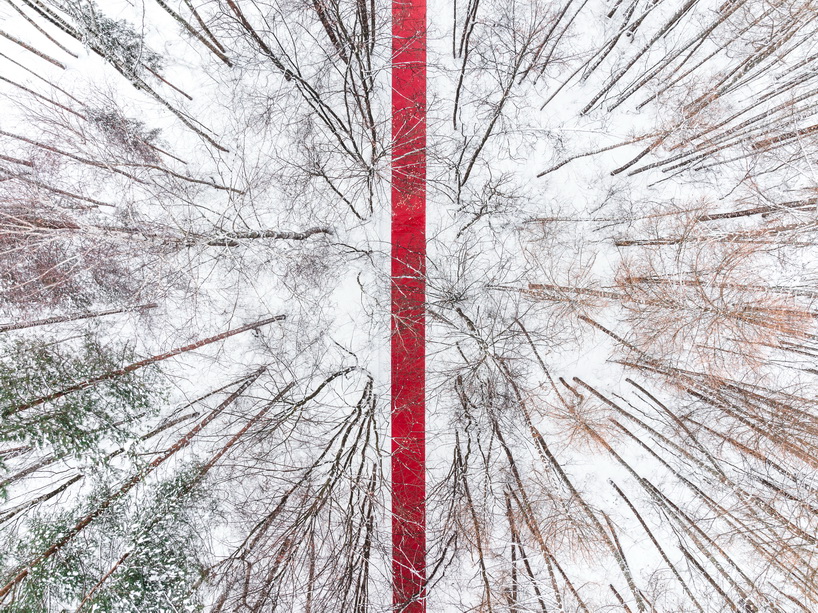 gregory orekhov rolls out 250-meter-long red carpet across snowy russian landscape