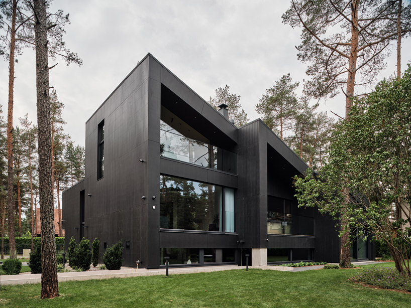 AZIA Arhitektid nestles 'a house for a family and bikes' into pine forest outside of tallinn