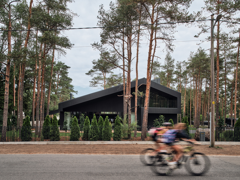 AZIA Arhitektid nestles 'a house for a family and bikes' into pine forest outside of tallinn