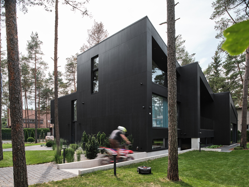 AZIA Arhitektid nestles 'a house for a family and bikes' into pine forest outside of tallinn