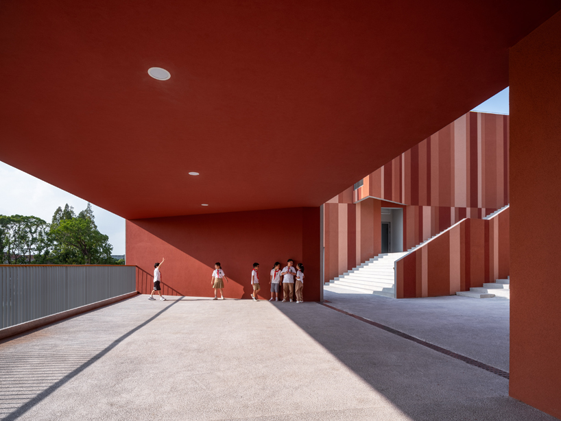 bright red striped patterns overlay fengpu elementary school's exterior in shanghai - 6