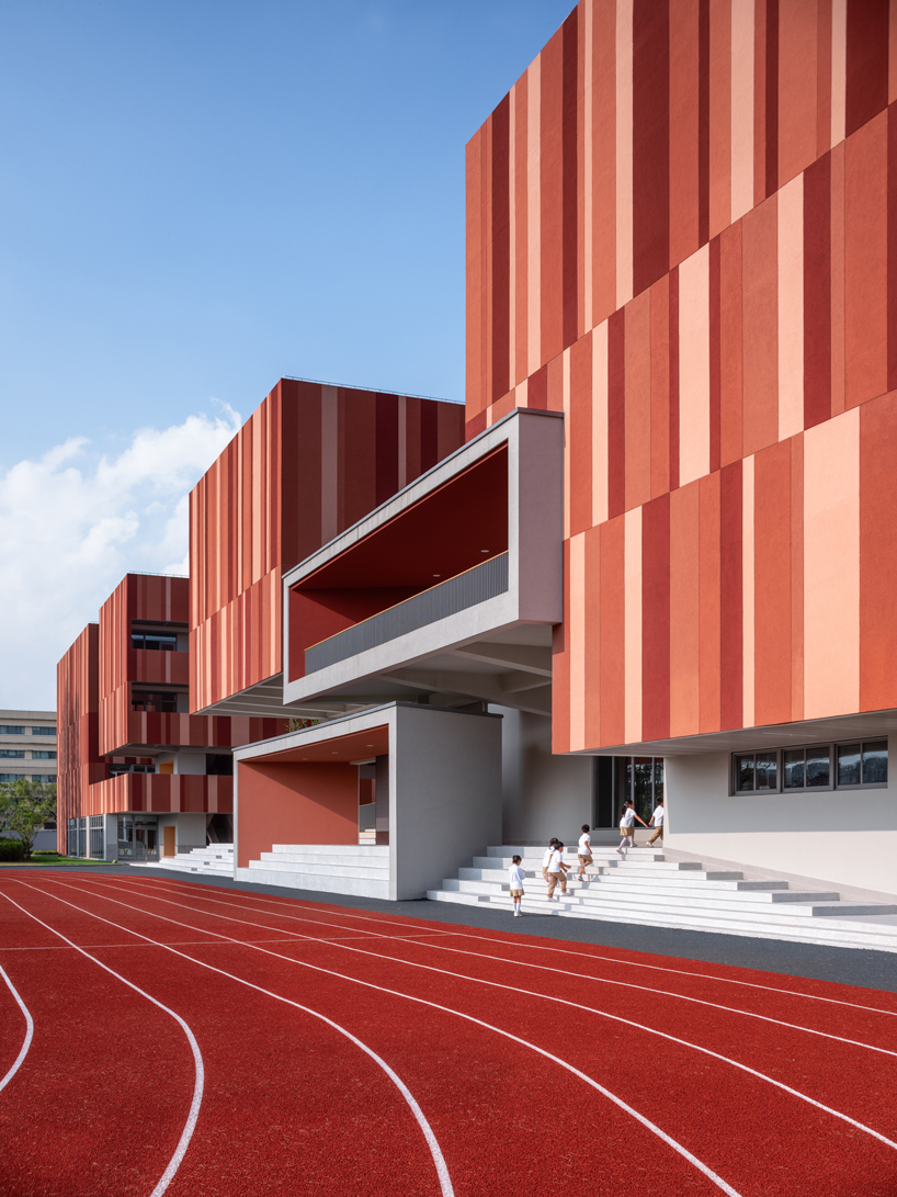 bright red striped patterns overlay fengpu elementary school's exterior in shanghai - 4