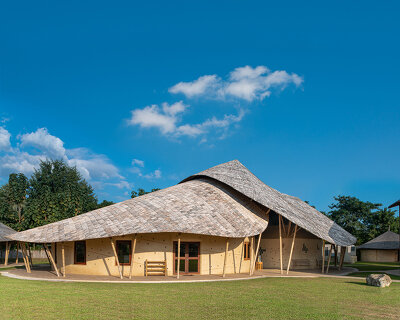 bamboo surfaces and organic shapes form sustainable science labs & music center in thailand