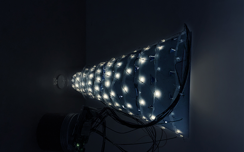 studio etain ho designs 'cone of radiance' light installation to brings joy & comfort to hong kong