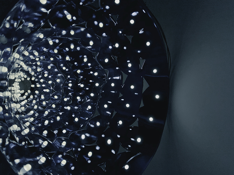 studio etain ho designs 'cone of radiance' light installation to brings joy & comfort to hong kong