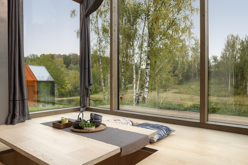 open AD designs three corten steel and glass cabins in rural latvia designboom