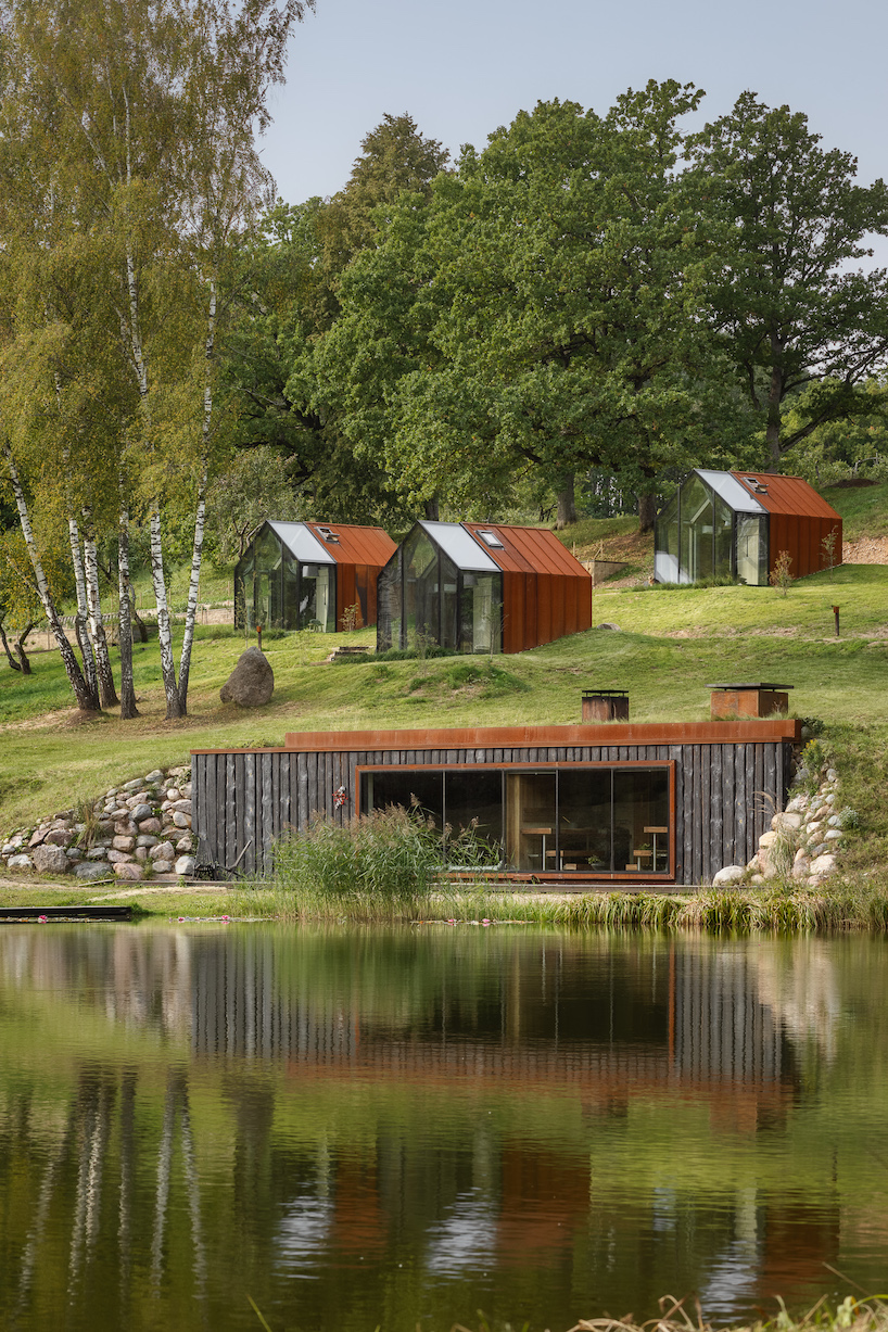 open AD designs three corten steel and glass cabins in rural latvia designboom