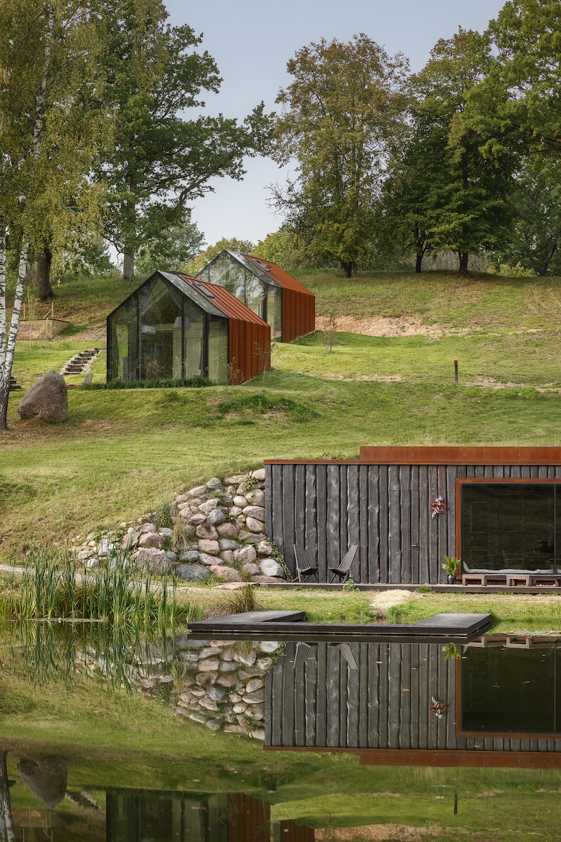 open AD designs three corten steel and glass cabins in rural latvia designboom