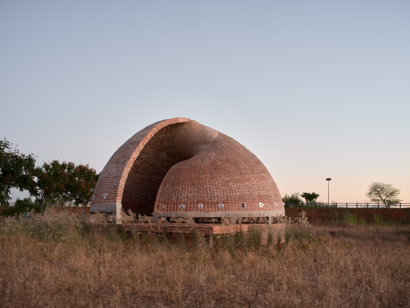HCCH studio stacks hundreds of red bricks to craft spiral shell library in china