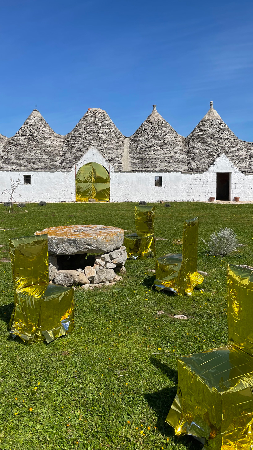 studio lievito wraps chairs in isothermal blankets for art installation in apulia