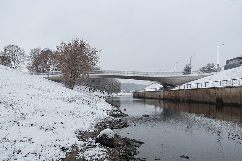 winding pedestrian bridge-plaza converges historic lithuanian city center with public park