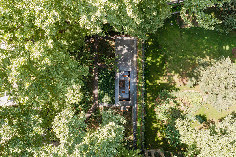 reconstructed steel lodge by pragmatica emerges from the greenery