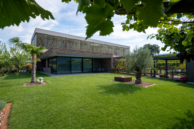 interwoven bronze façade adorns dwelling by monovolume architecture+design, italy