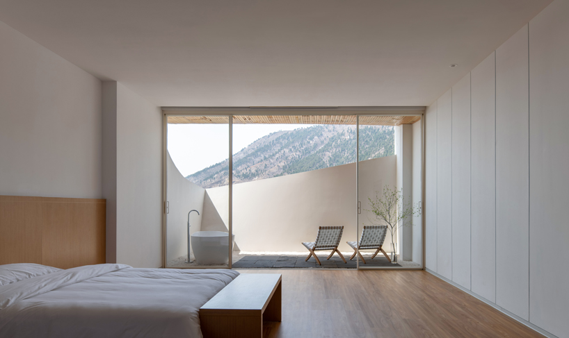curved white wall façade adorns new hotel model in industrial site of china - 1