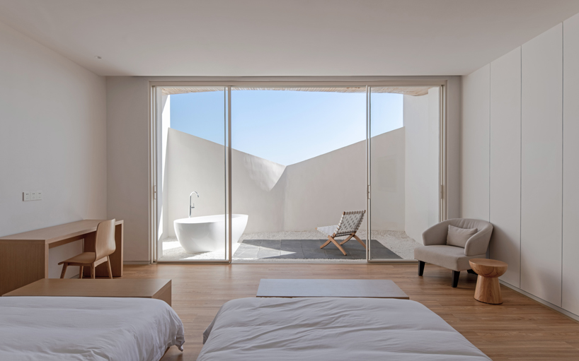 curved white wall façade adorns new hotel model in industrial site of china - 2
