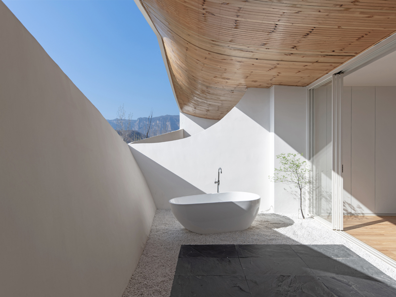curved white wall façade adorns new hotel model in industrial site of china - 3