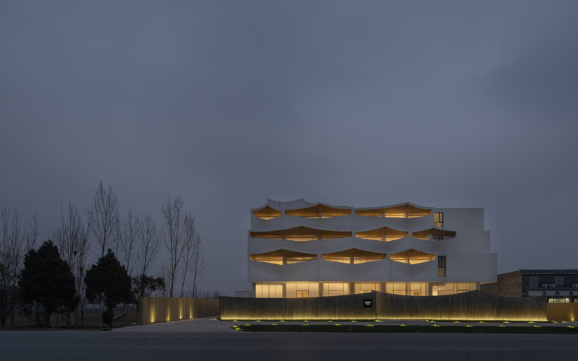 curved white wall façade adorns new hotel model in industrial site of china - 5