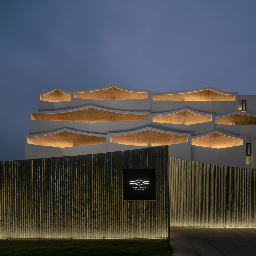 curved white wall façade adorns new hotel model in industrial site of china - 6