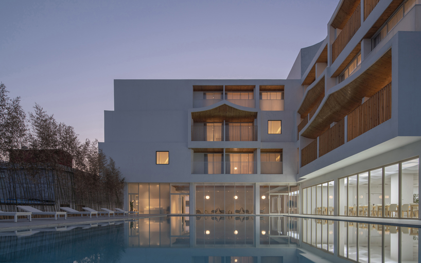 curved white wall façade adorns new hotel model in industrial site of china - 4