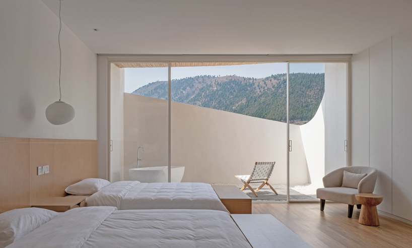 curved white wall façade adorns new hotel model in industrial site of china